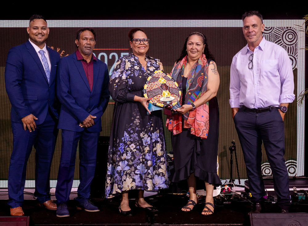A diverse group of First Nations community leaders, elders, and industry professionals standing side-by-side on stage at a national resources awards dinner.