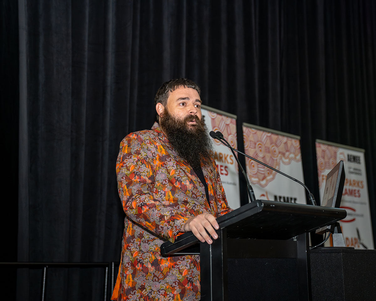 A medium shot of the BlackRock Industries representative addressing the audience at the podium during the 17th Annual AEMEE Awards Night.