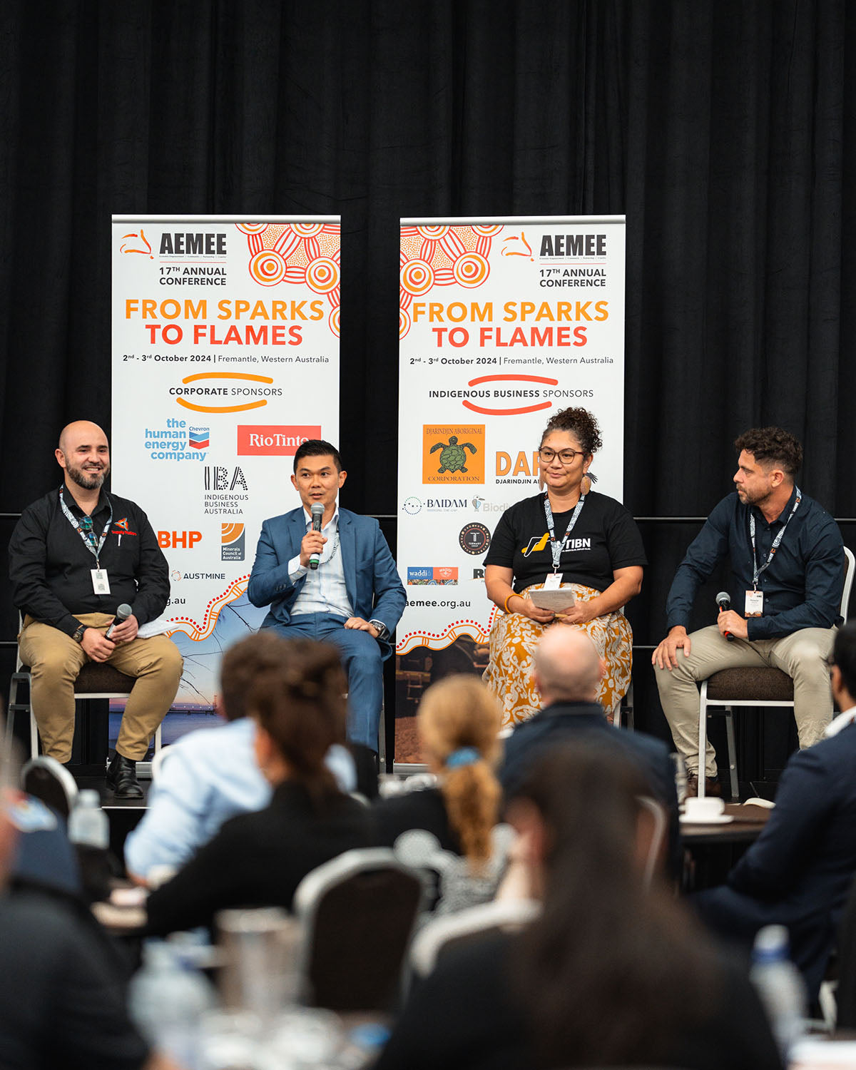 An industry partner speaking into a microphone during a collaborative plenary panel focused on procurement in the Indigenous business resources sector.
