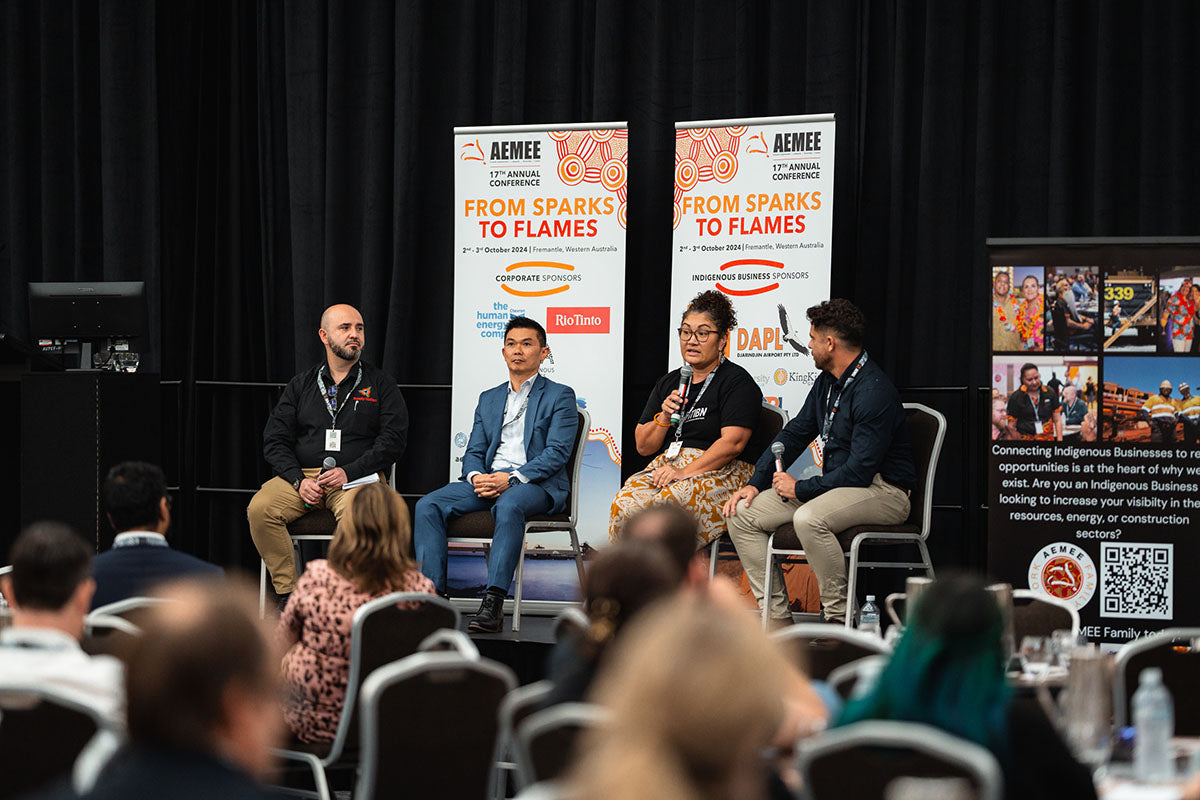 An industry panel sharing insights from the stage, viewed across an audience of seated delegates at the annual AEMEE conference.