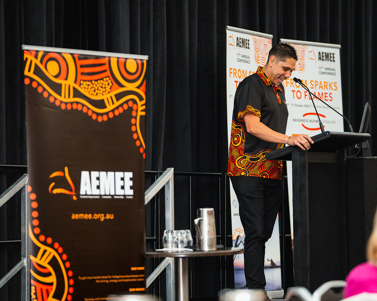 Jyi Lawton, CEO of AEMEE, at the podium at the AEMEE 2024 Annual Conference Day 1 — From Sparks to Flames, Fremantle Western Australia