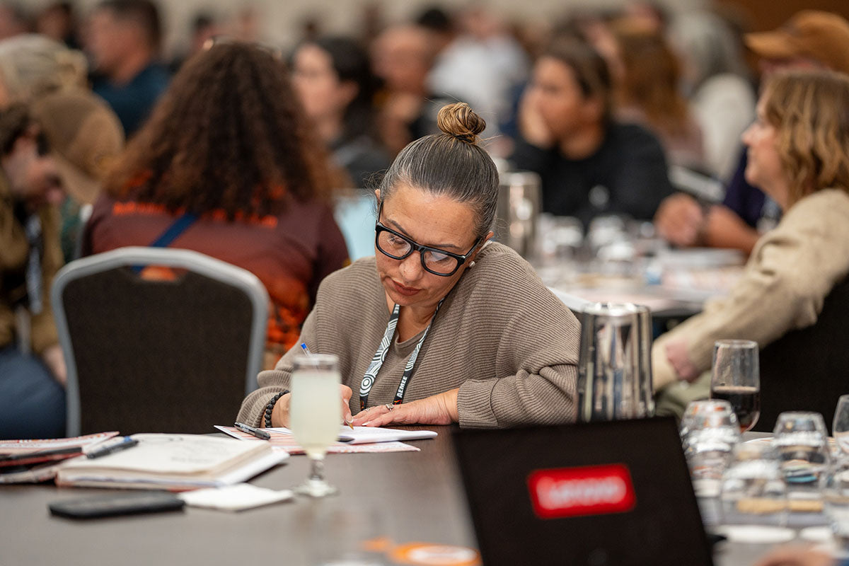Delegate taking notes during Session 2: Tracking the Journey at the 2024 AEMEE Annual Conference in Fremantle, WA.