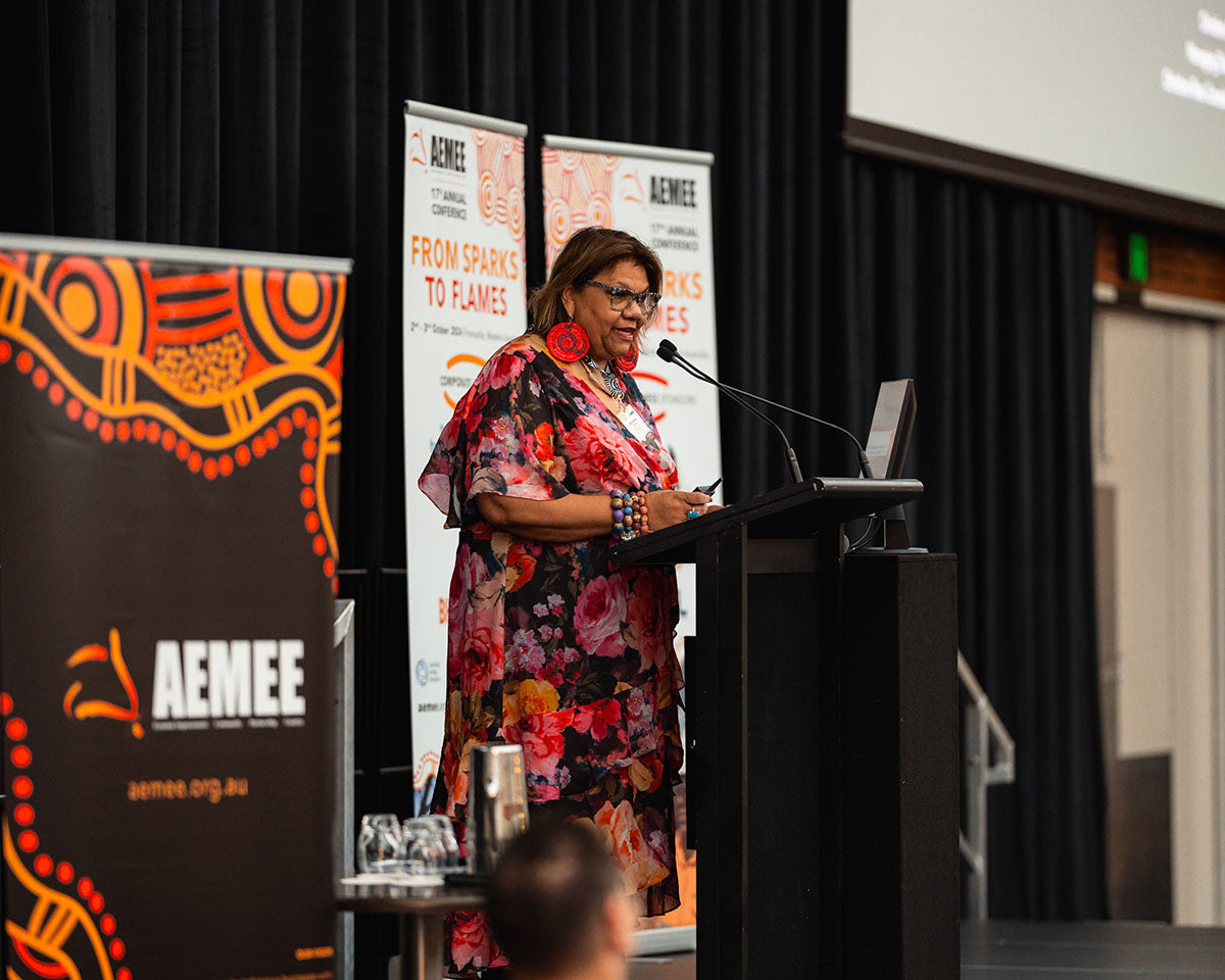 Christine Ross speaking at the podium during her presentation at the 2024 AEMEE Annual Conference in Fremantle, WA.
