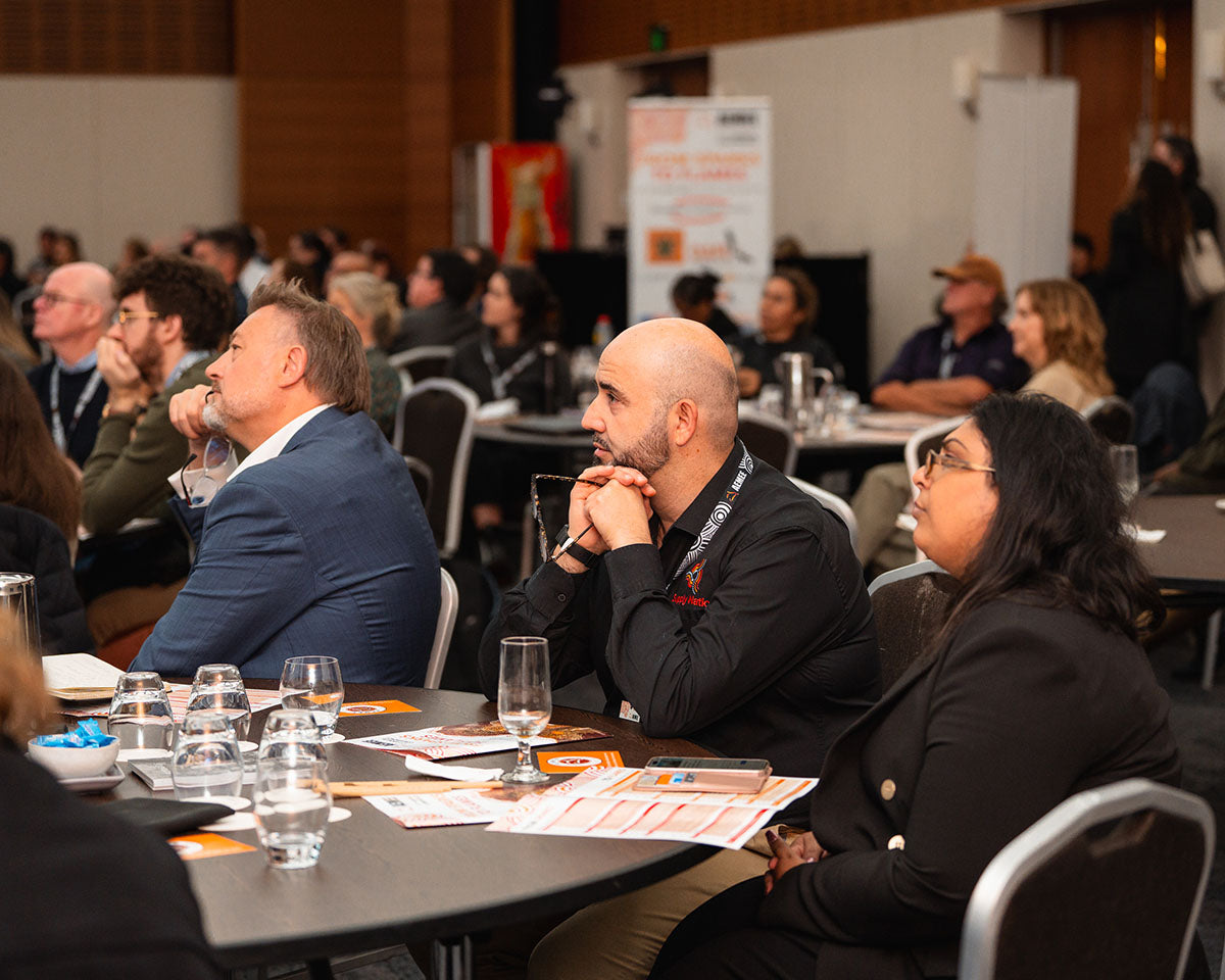 Seated industry professionals and community stakeholders listening closely to an interactive stage panel discussion on Equity & Ownership models.
