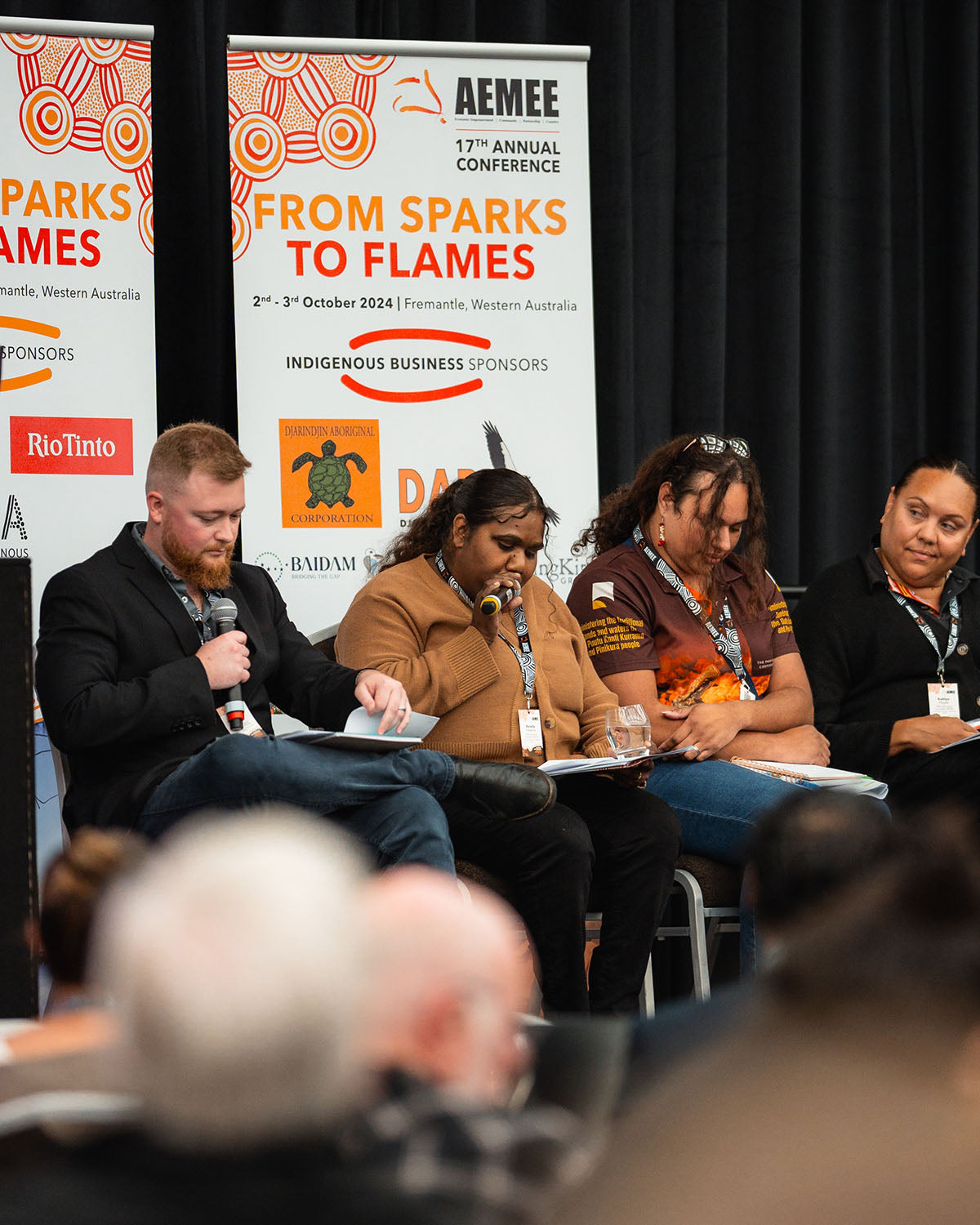 A diverse industry panel speaking on stage during the "From Sparks to Flames" interactive session focused on growth in the Indigenous business resources sector.