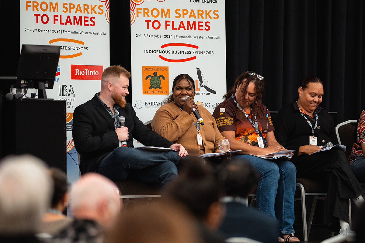 Panelists sharing a microphone and interacting during a collaborative presentation at the annual national AEMEE conference.