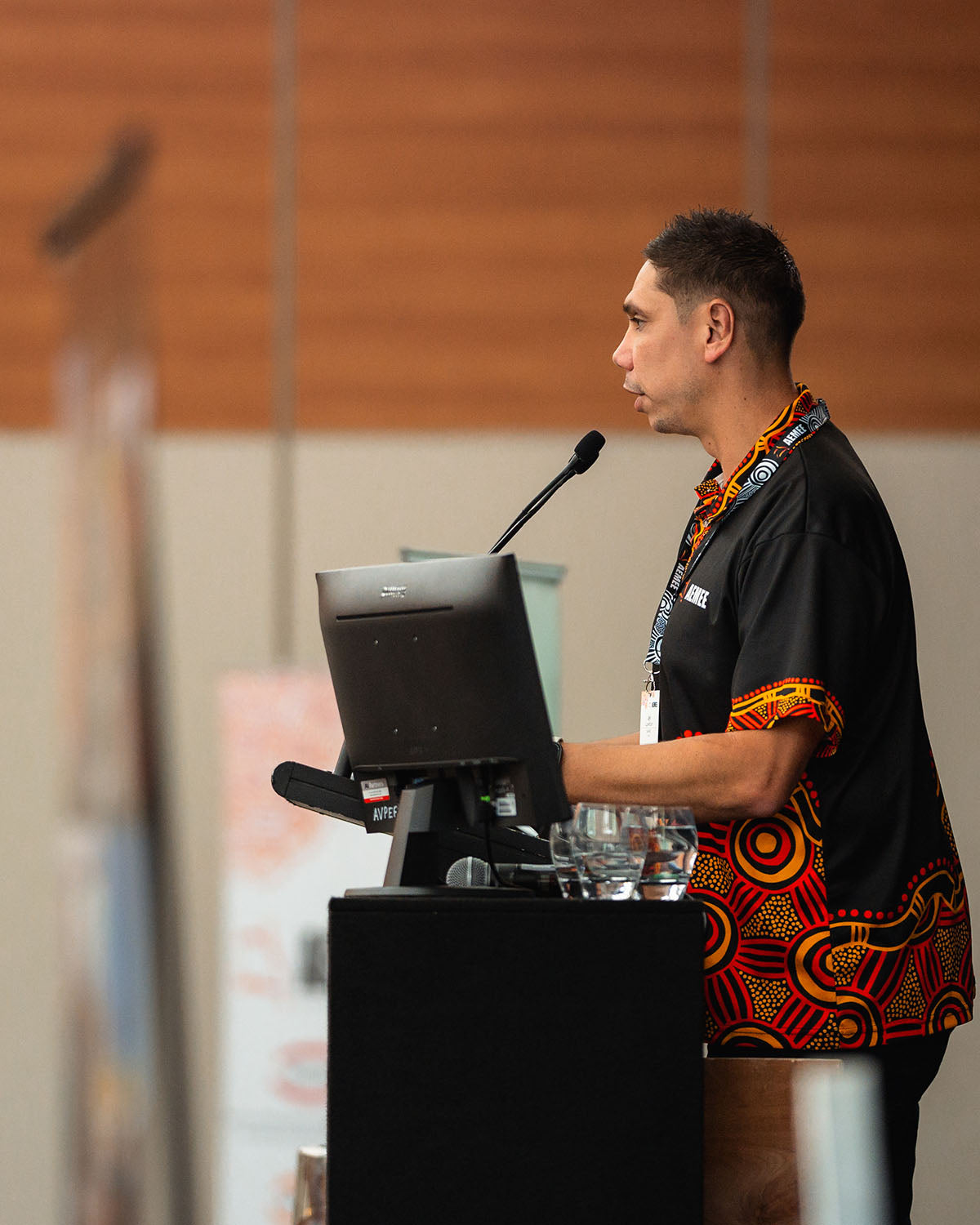 AEMEE CEO Jyi Lawton delivering an executive address from the stage podium, highlighting strategic data pathways for the Indigenous business resources sector.