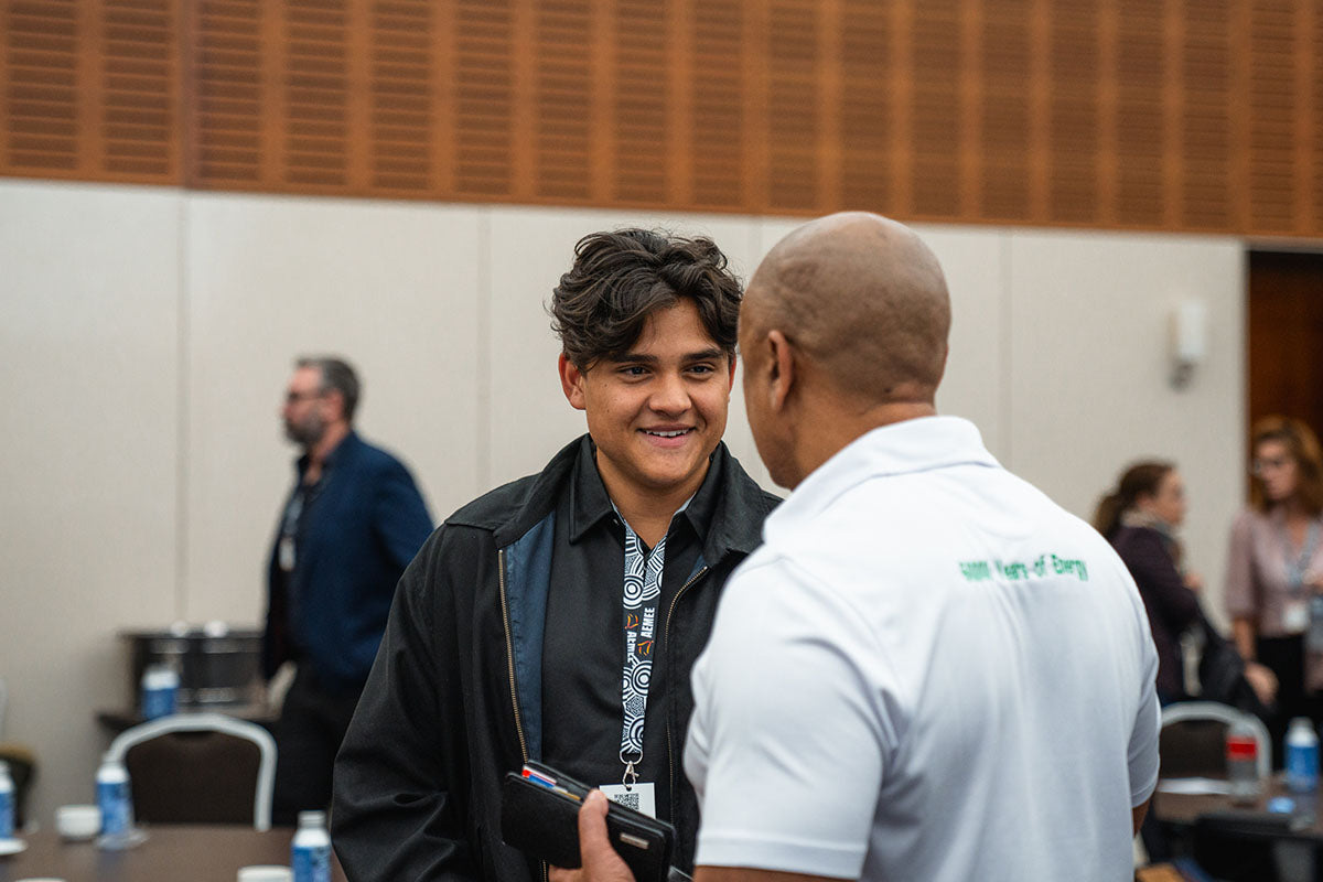 Business professionals and corporate partners talking and smiling during a final afternoon networking session at the annual AEMEE conference.