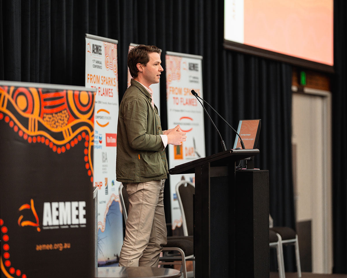 A male speaker delivering a presentation during a resource sector stream breakout focusing on scalable procurement pathways.