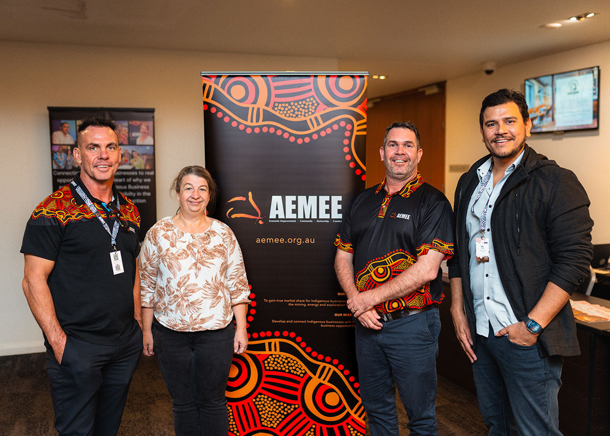 AEMEE Chairperson Derek Flucker, an industry delegate, AEMEE CEO Jyi Lawton, and Board Member Raymond Pratt standing together during a networking break at the national conference