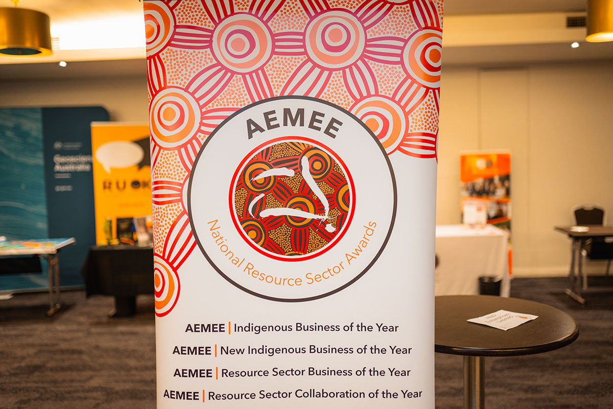 An official awards pull-up banner listing key gala award categories, including Indigenous Business of the Year, New Indigenous Business of the Year, and Resource Sector Collaboration of the Year.