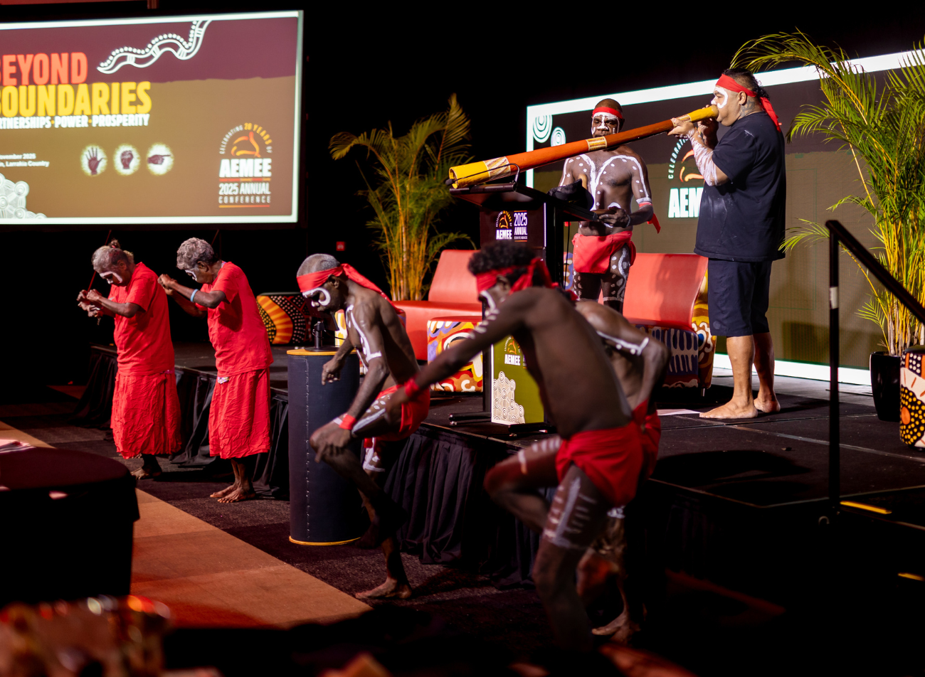 Traditional Indigenous cultural performance with dancers and didgeridoo on stage at the AEMEE 2025 Annual Conference Day 1 in Darwin — Beyond Boundaries: Partnerships, Power, Prosperity