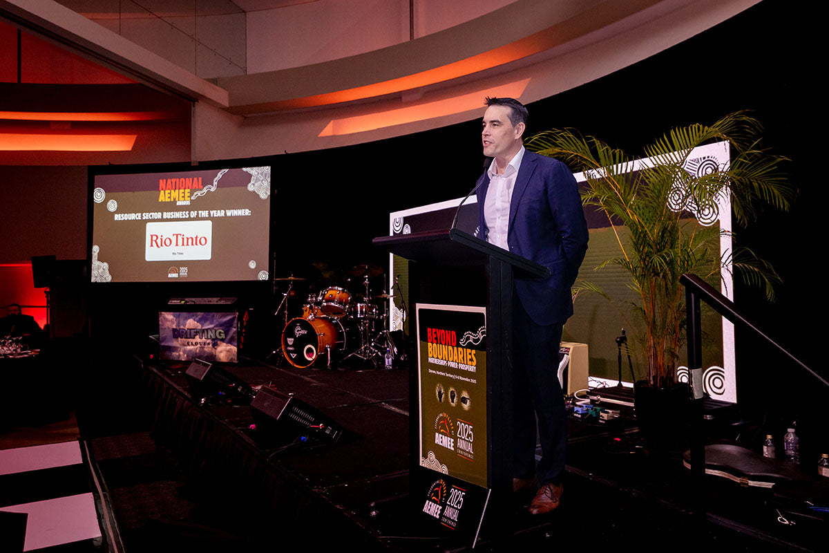 Speaker presenting from the podium during the Rio Tinto sponsor address at the AEMEE 2025 Annual Conference.