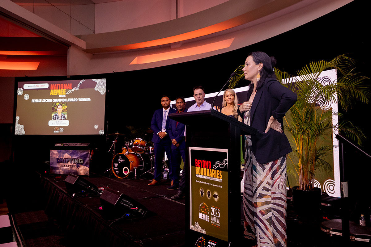 Kia Dowell speaking at the podium during the National AEMEE Awards at the 2025 Annual Conference.