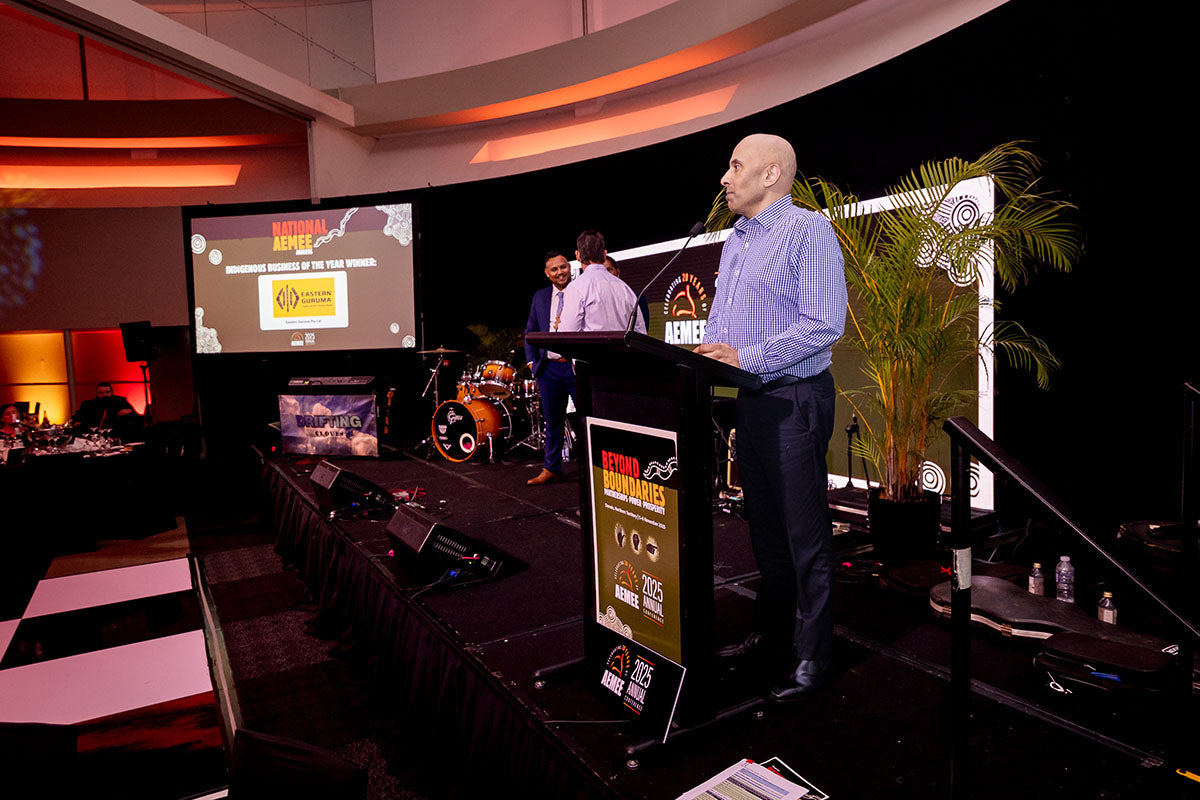 Speaker presenting the 2025 Judges' Choice Award for Gooring Jimbila Contracting at the AEMEE 2025 Annual Conference.