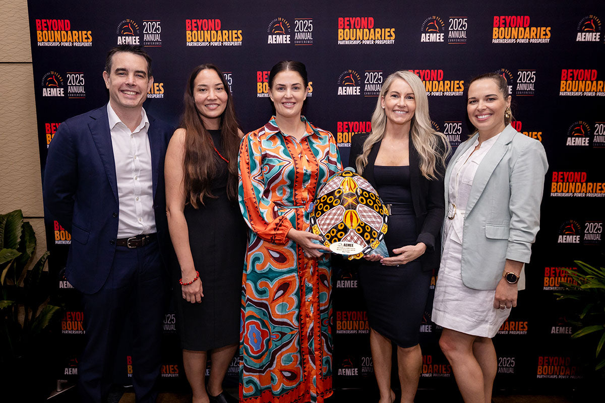 Rio Tinto representatives celebrating the 2025 Resource Sector Business of the Year award at the AEMEE Annual Conference media wall.