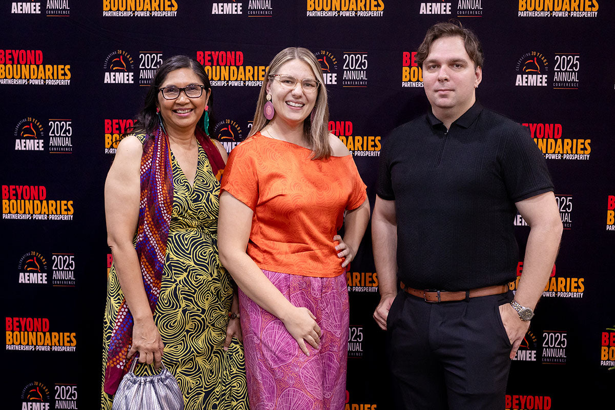 Delegates posing at the AEMEE 2025 National Resource Sector Awards gala dinner backdrop, Darwin