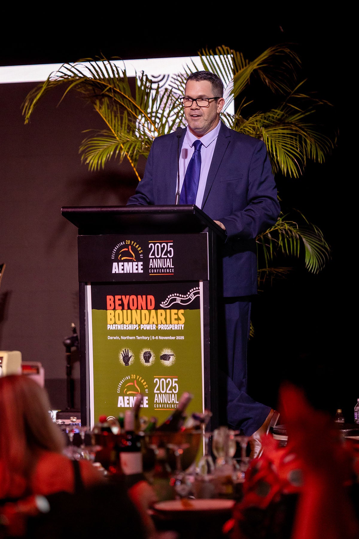 Speaker presenting from the podium at the AEMEE 2025 Annual Conference.