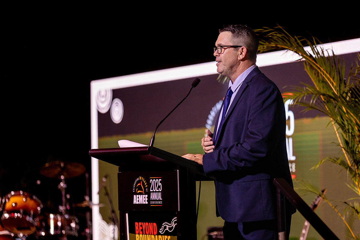 Speaker presenting from the podium at the AEMEE 2025 Annual Conference.
