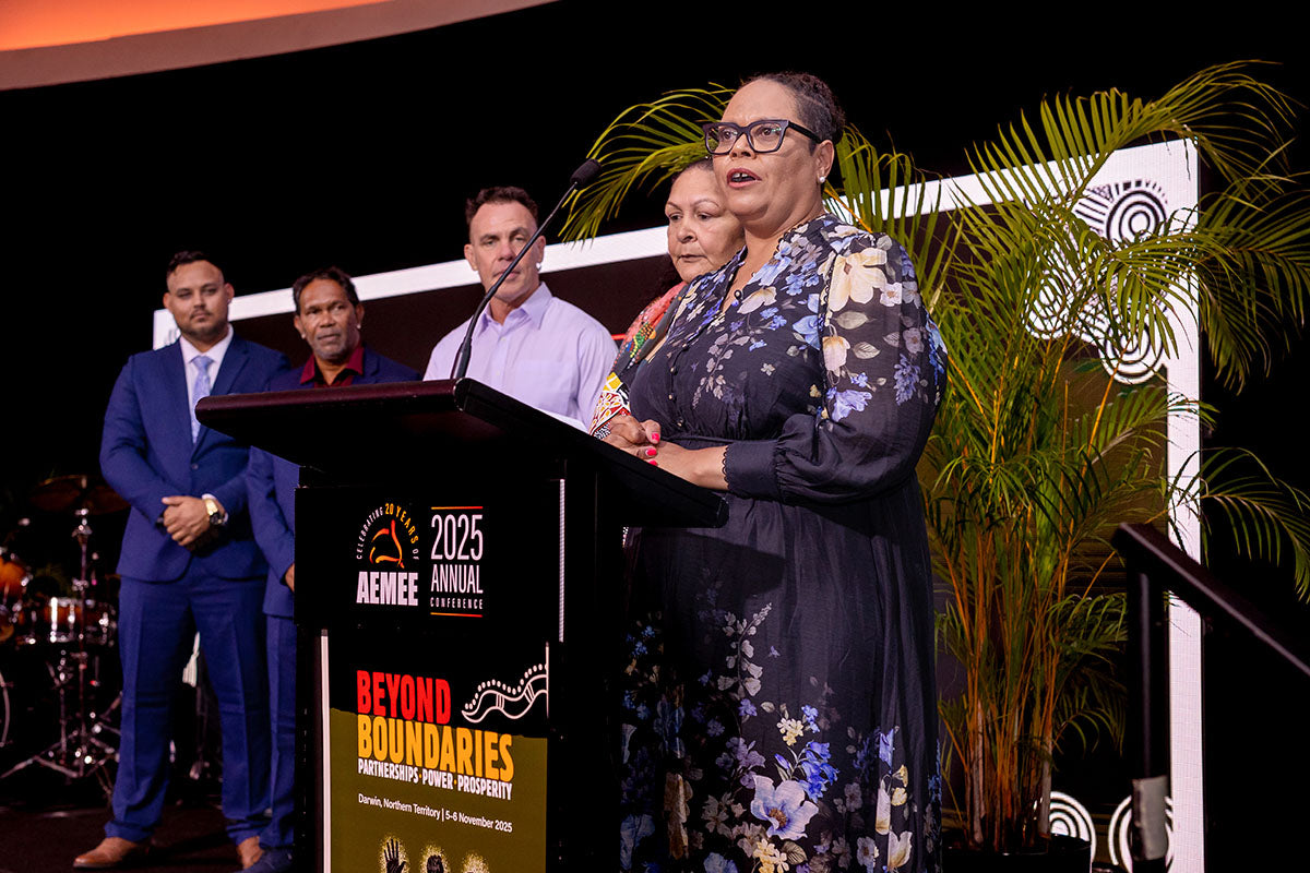 Award recipient speaking at the podium during the National AEMEE Awards ceremony.