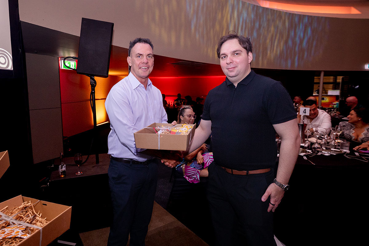 AEMEE conference guest receiving a gift box during the 2025 Annual Conference awards dinner.