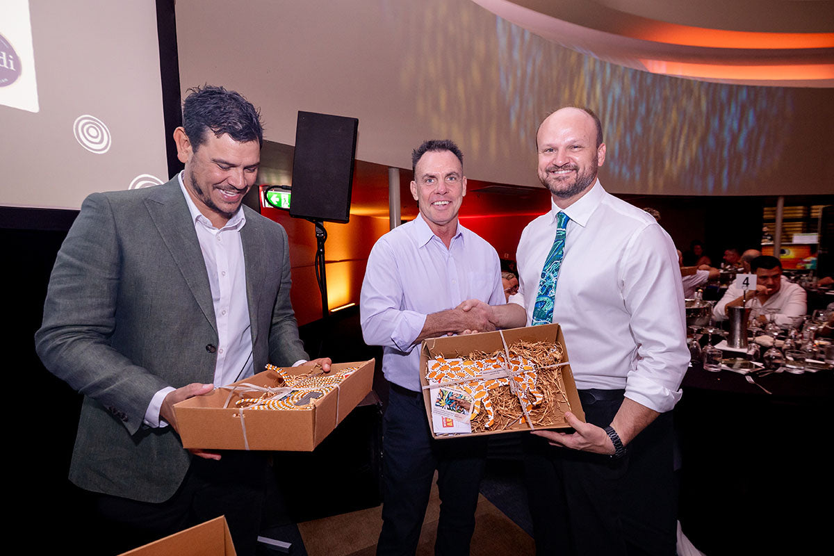 AEMEE conference presenters sharing gift boxes with guests during the 2025 Annual Conference awards dinner.