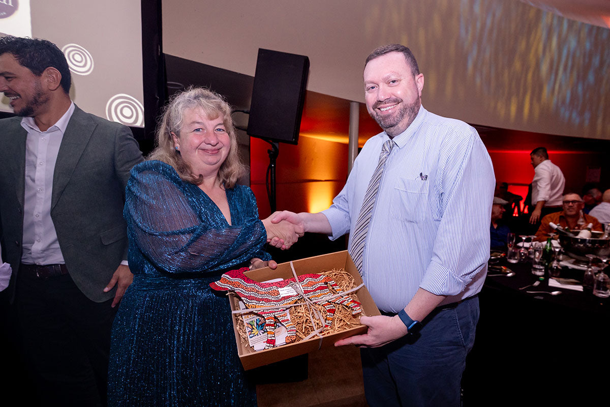AEMEE conference guest receiving a gift box during the 2025 Annual Conference awards dinner.