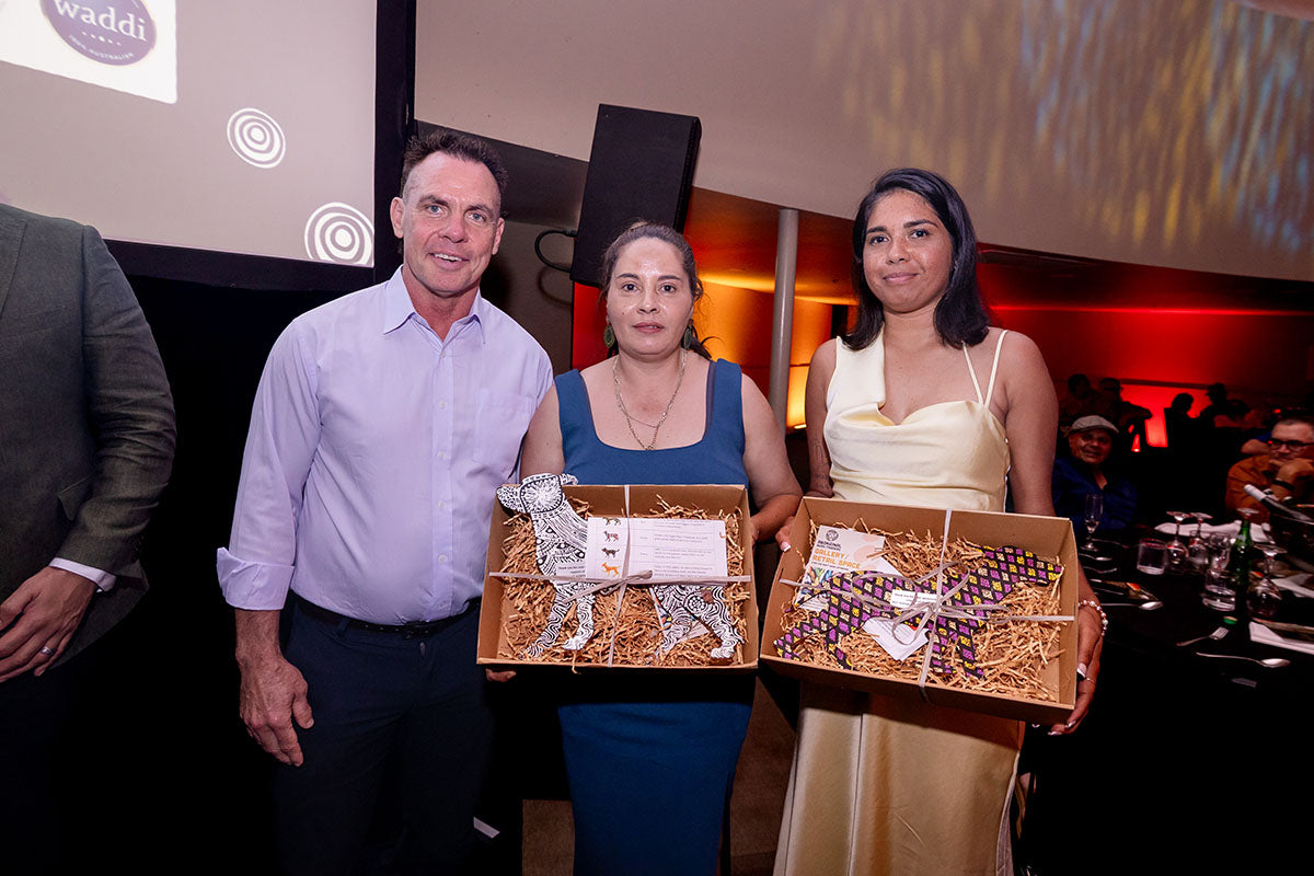 AEMEE conference guests posing with gift boxes during the awards dinner.