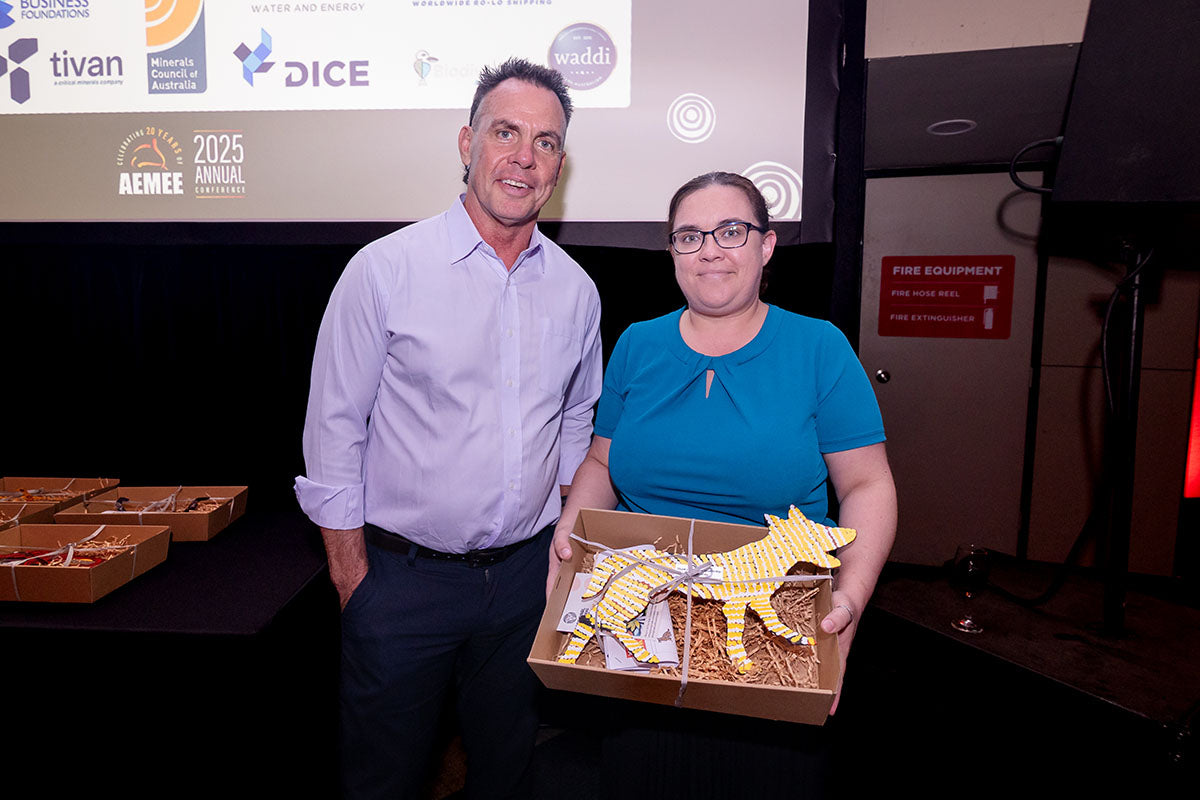 AEMEE conference guest holding a gift box during the awards dinner.