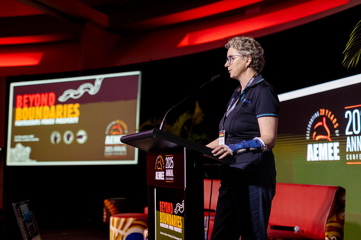 Indigenous Elder at the podium at the AEMEE 2025 Annual Conference Day 1, Darwin