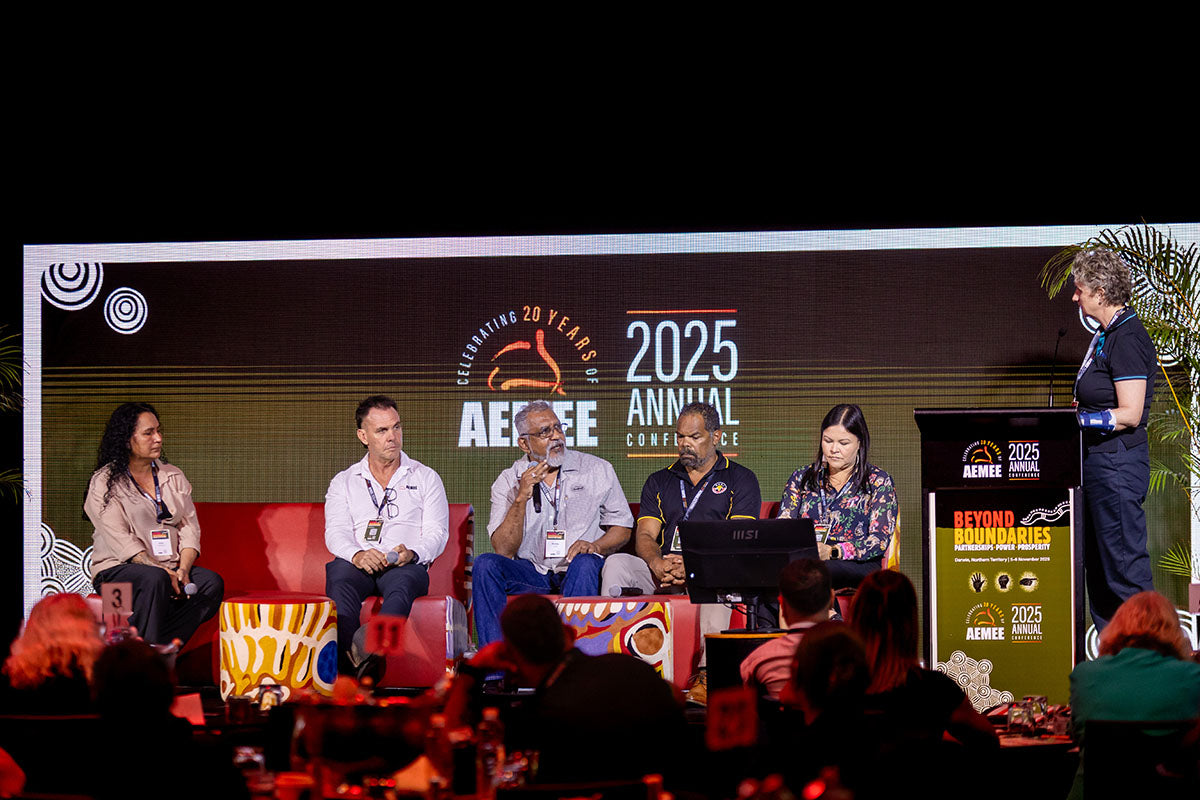 Wide view of an AEMEE conference panel session with speakers discussing Indigenous business and resources sector collaboration.