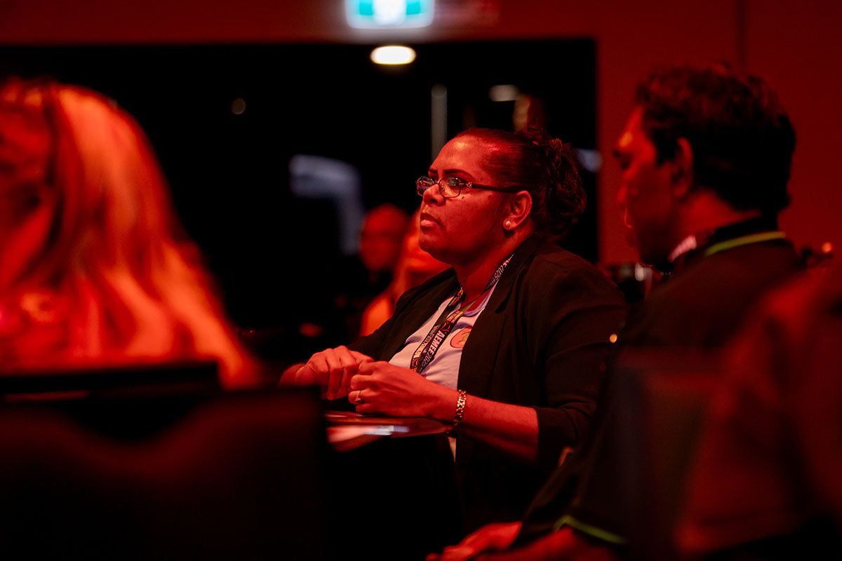 Delegate listening during an AEMEE conference session focused on Indigenous business and resources sector collaboration.