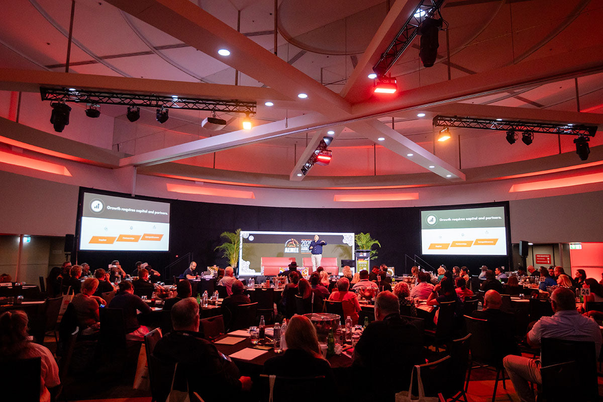 Wide view of the AEMEE conference audience and stage during an Indigenous business resources sector session.