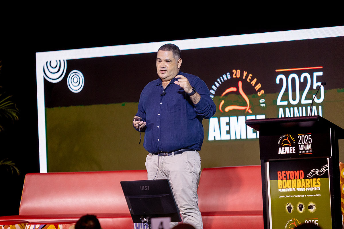 Speaker presenting on stage at the AEMEE 2025 Annual Conference.