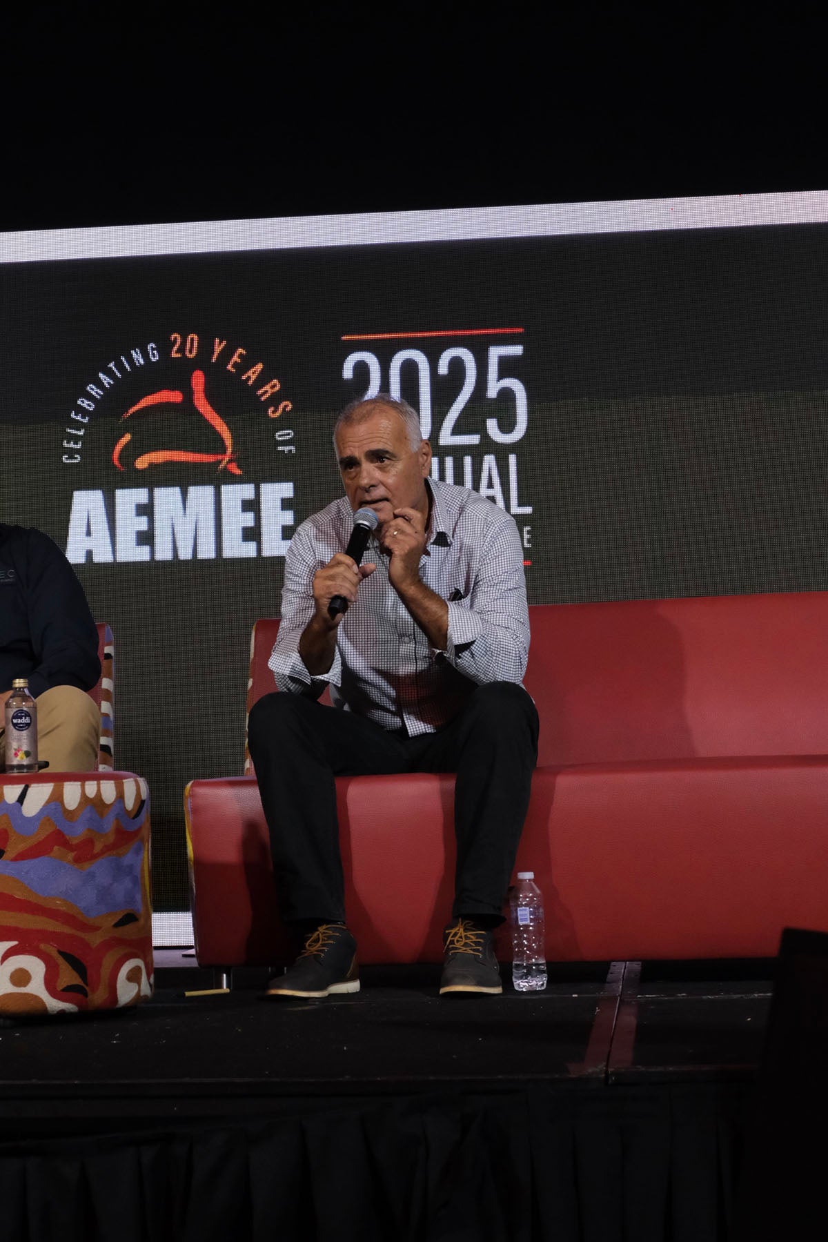 AEMEE conference speaker sharing insights during a panel discussion on Indigenous business and sector collaboration.