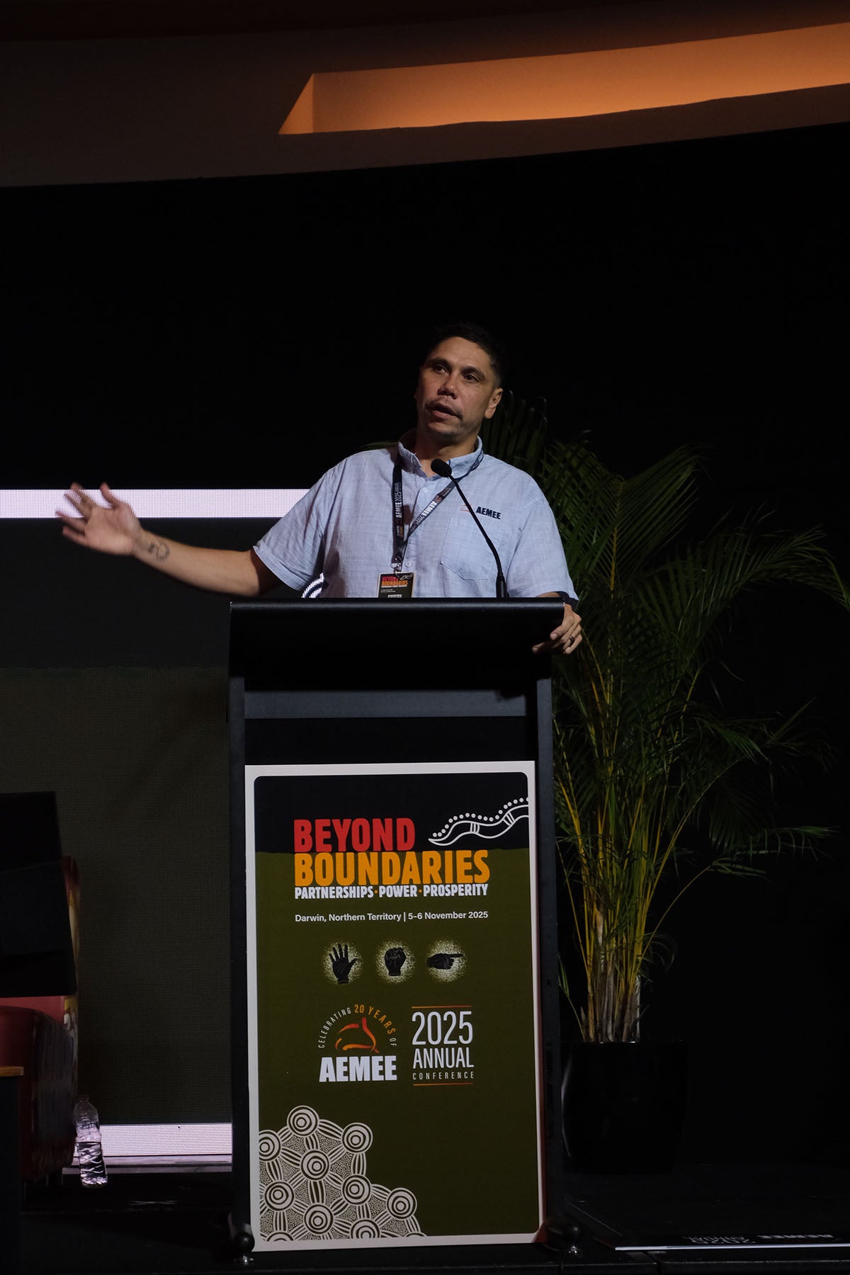 CEO Jyi Lawton speaking from the podium during an AEMEE conference session on Indigenous business and sector collaboration.