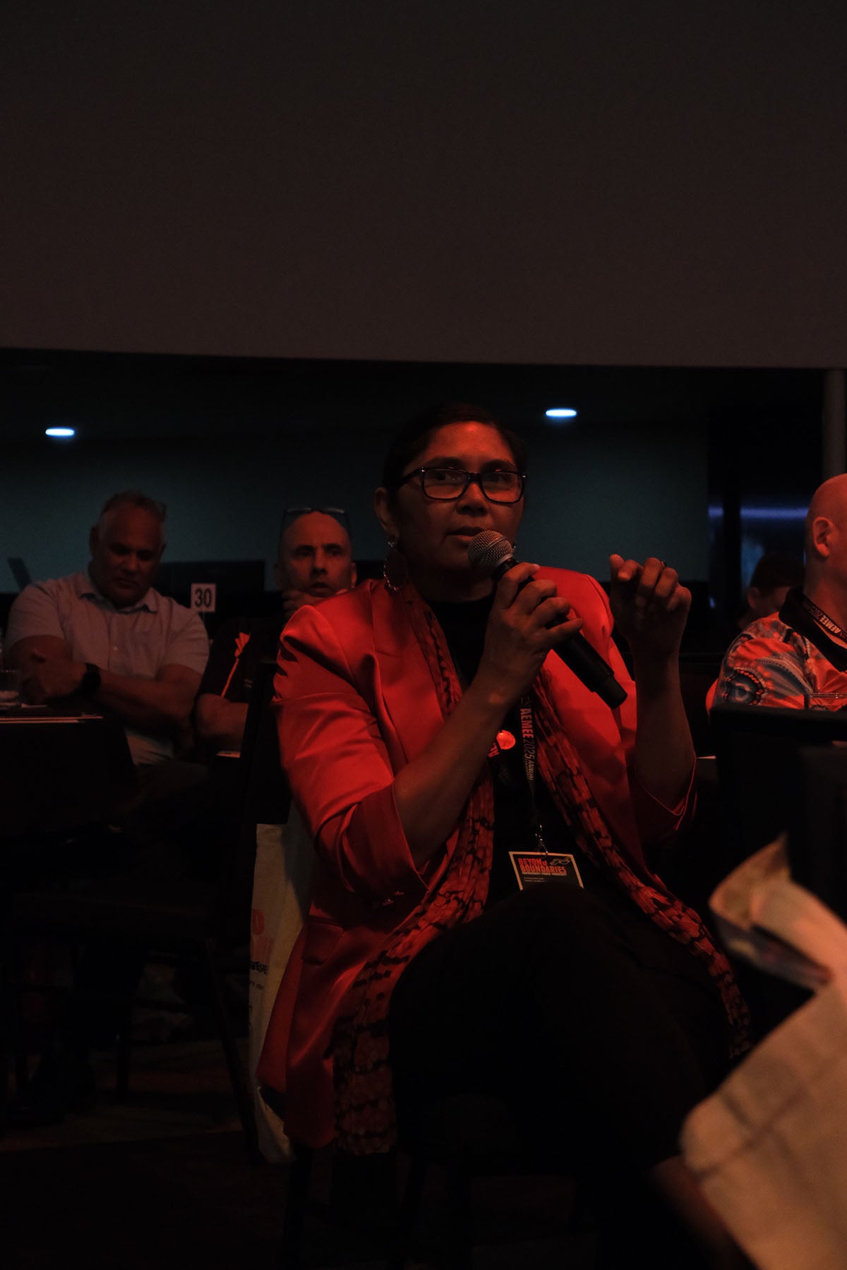 Delegate asking a question during an AEMEE conference session on Indigenous business and resources sector collaboration.