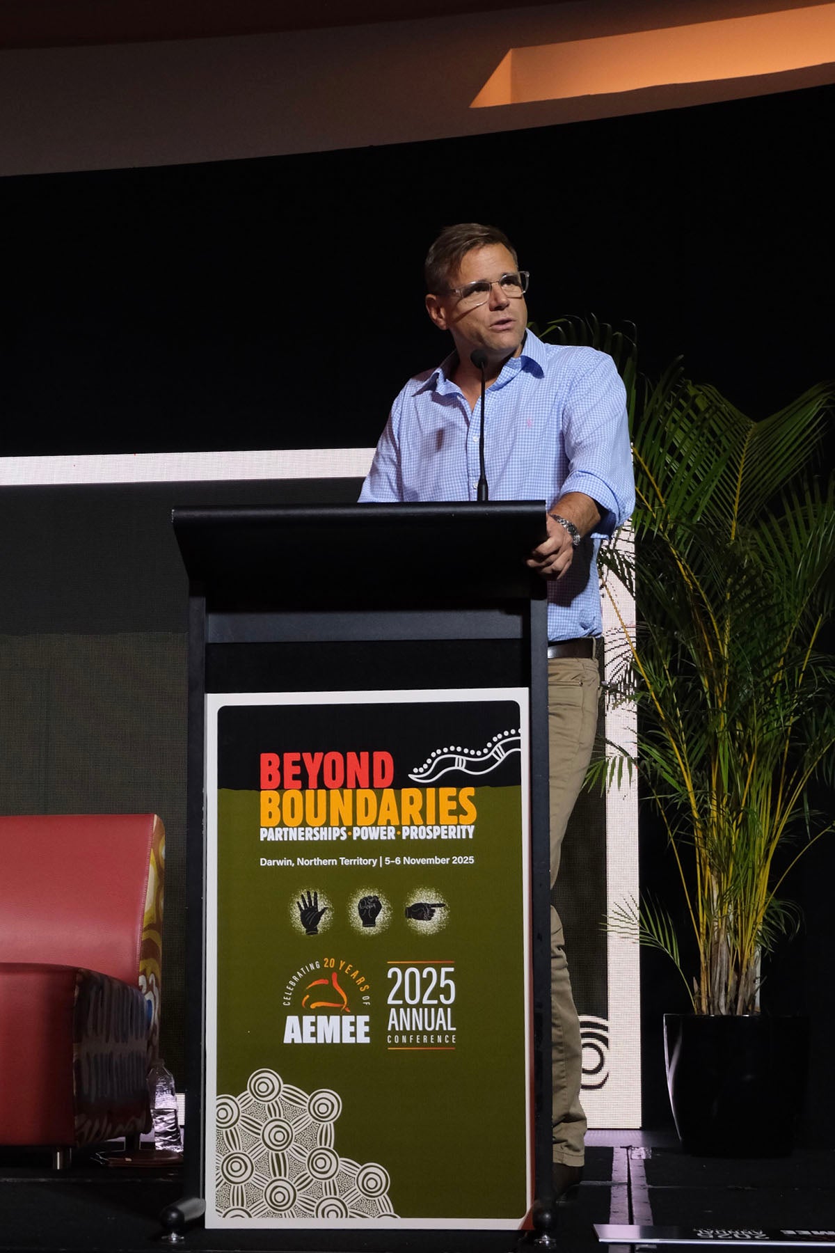 Presenter speaking from the podium at the AEMEE conference during an Indigenous business resources sector session.