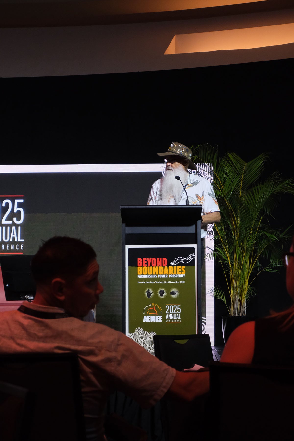 Speaker presenting from the podium at the AEMEE 2025 Annual Conference during a Beyond Boundaries session.
