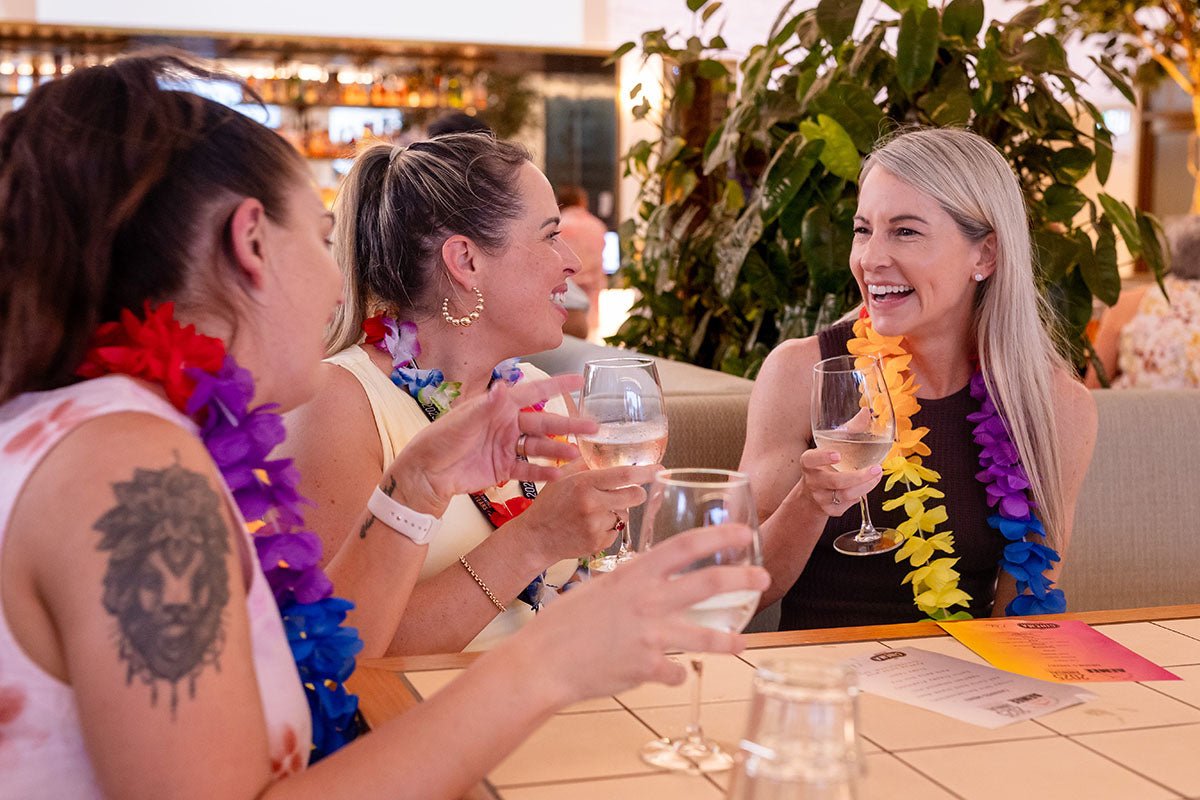 Delegates celebrating at the AEMEE 2025 Annual Conference networking night in Darwin, wearing Hawaiian leis