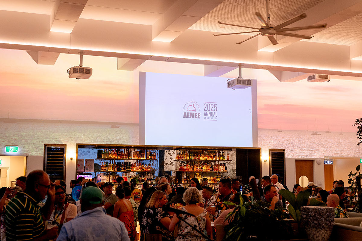 Full venue at the AEMEE 2025 Annual Conference networking night in Darwin, with AEMEE 2025 branding on screen