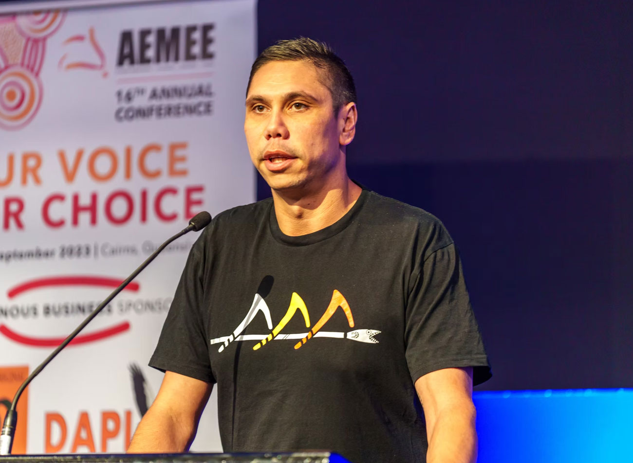 AEMEE Chief Executive Jyi Lawton delivering an operational policy address from the national conference stage.