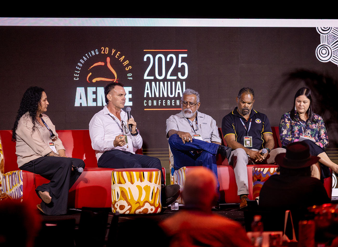 An active panel discussion on stage at the AEMEE conference, featuring industry representatives from the Minerals Council of Australia discussing project co-ownership models.