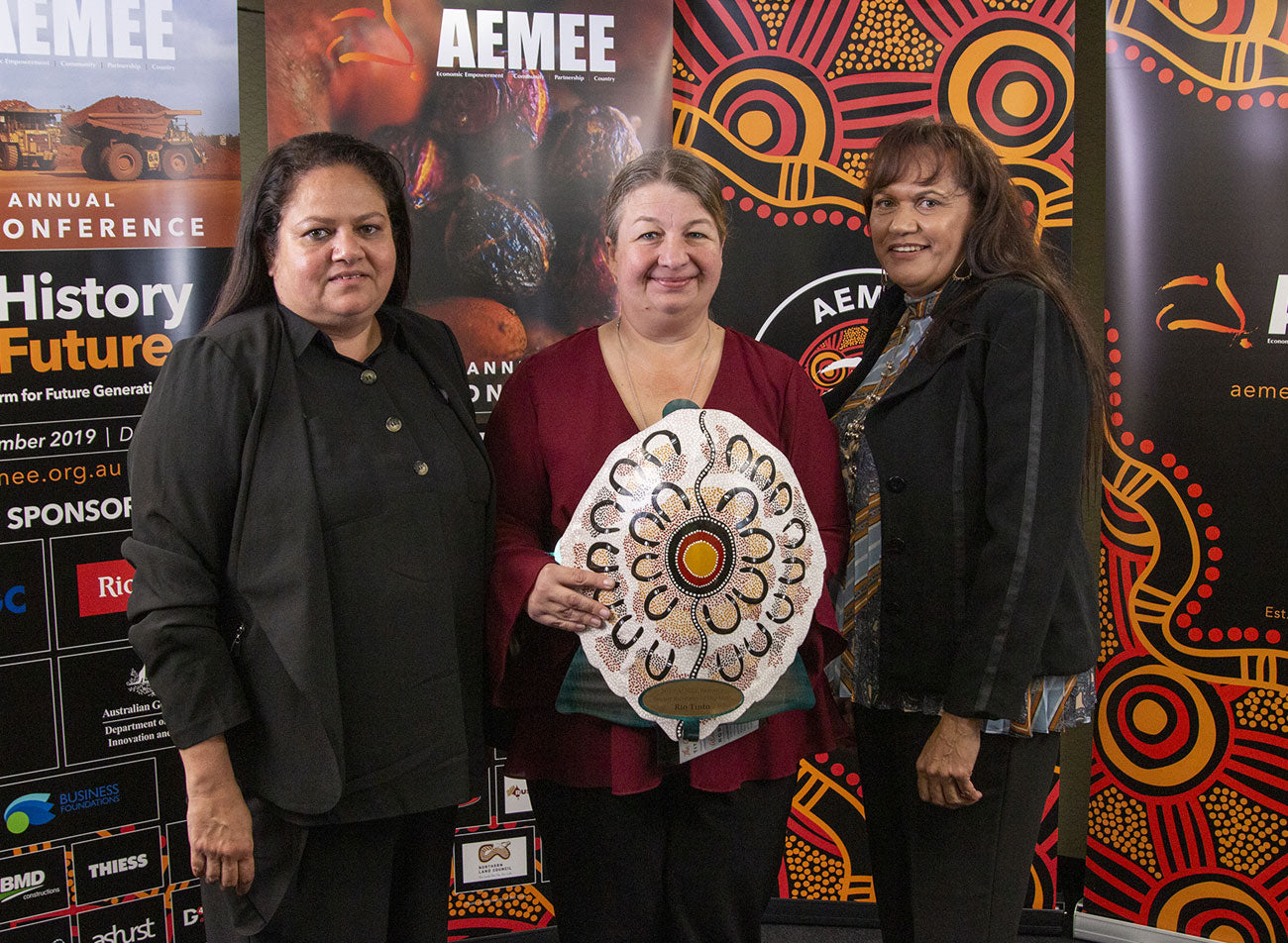 Proud First Nations business owners and strategic corporate partners standing together on stage with their official hand-painted shield trophies at the 2019 AEMEE Awards gala.